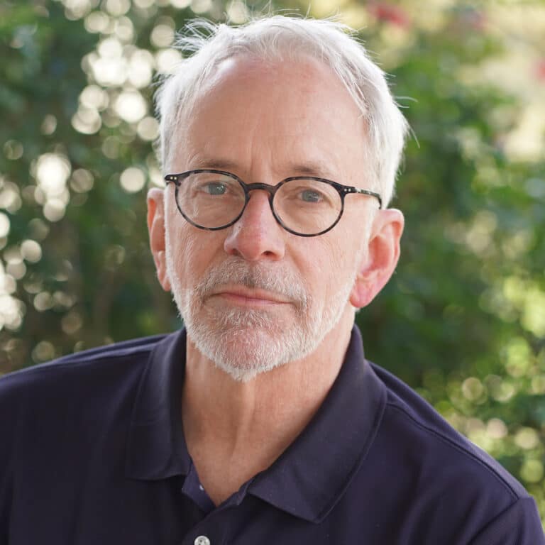 Older man with glasses outdoors portrait