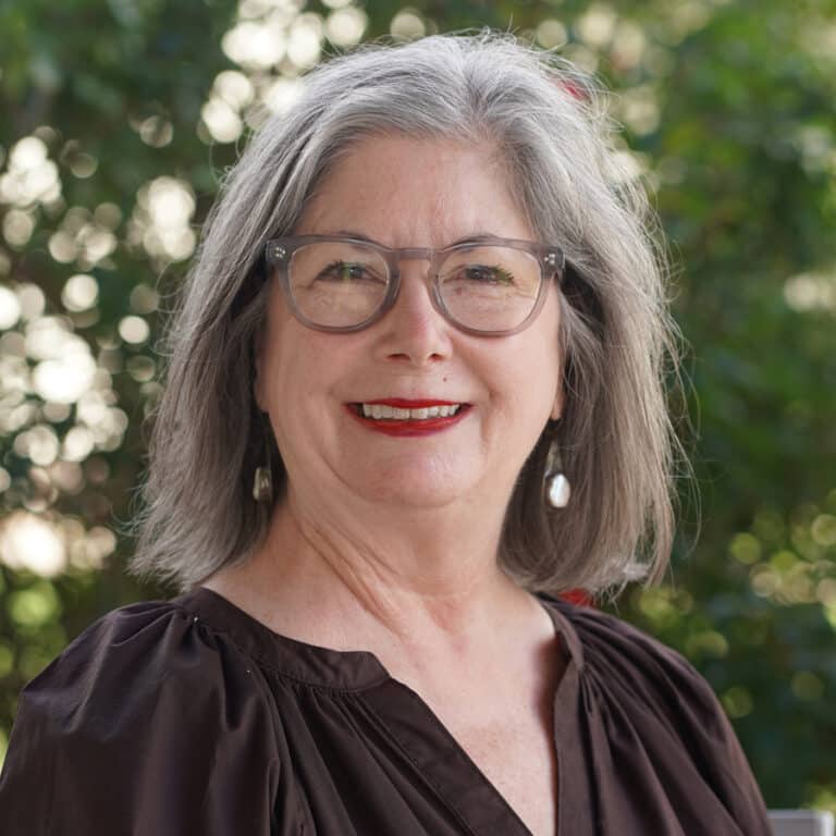 Smiling older woman with gray hair outdoors