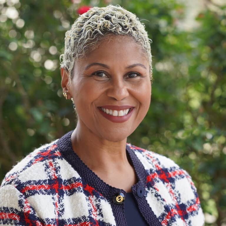 Smiling woman with short gray hair outdoors